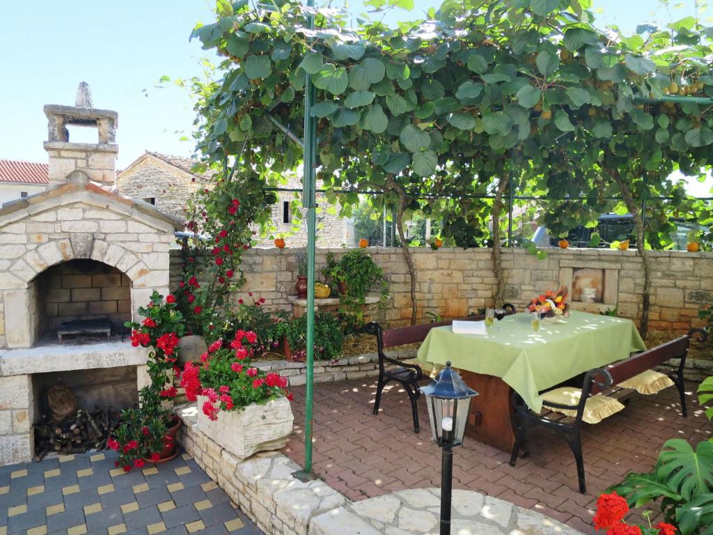 a patio with a table and a fireplace at Holiday Home Milka 1 - ROJ315 by Interhome in Svetvinčenat