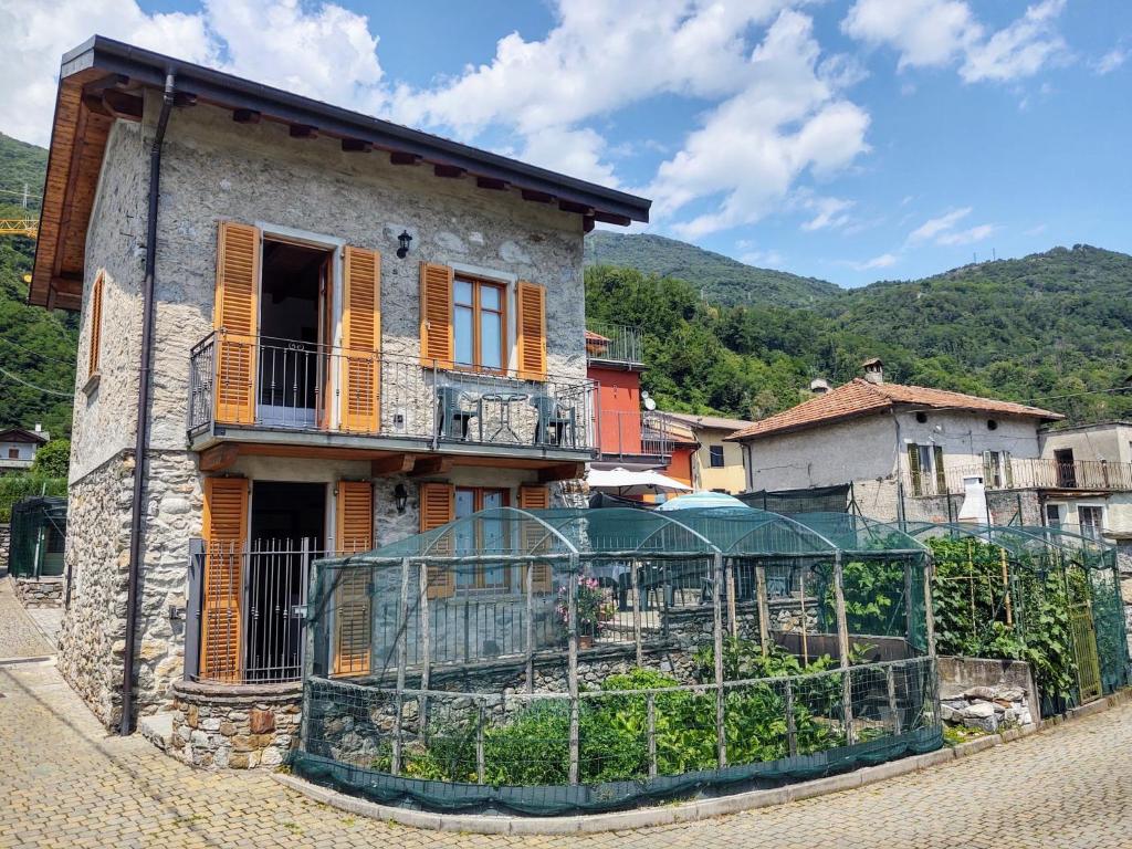 an old house with a fence in front of it at Holiday Home Leonardo by Interhome in Sorico