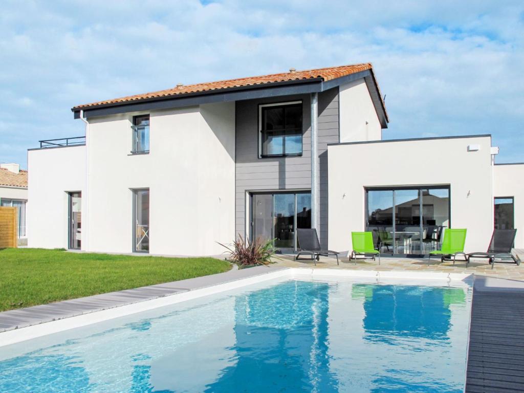 uma casa com uma piscina em frente em Apartment Les Epinettes by Interhome em Saint-Gilles-Croix-de-Vie