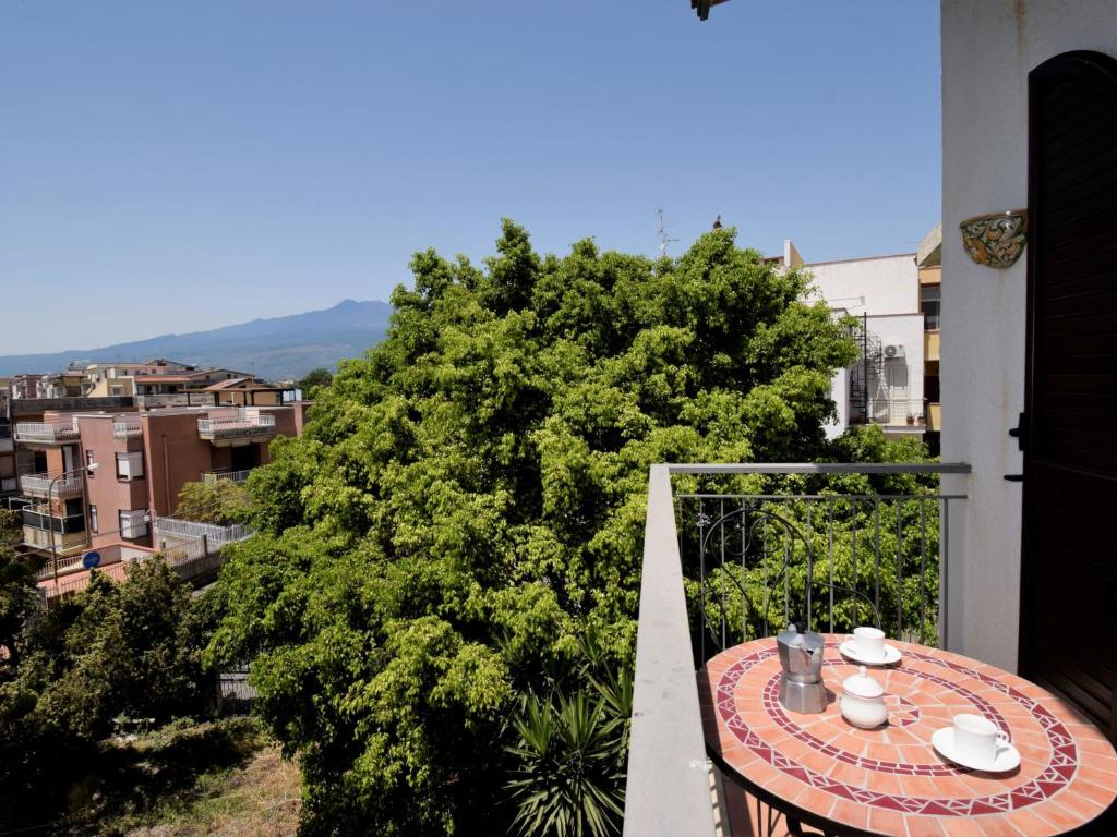 a table on the balcony of a building at Apartment Casa Teste di Moro by Interhome in Giardini Naxos