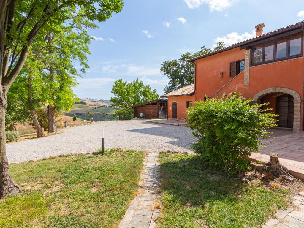 an empty driveway to a house with a tree at Apartment I Due Carpini-3 by Interhome in Citta' Sant'Angelo