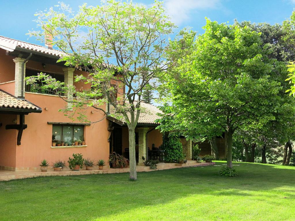 a house with a green yard in front of it at Apartment I Due Carpini-2 by Interhome in Citta' Sant'Angelo