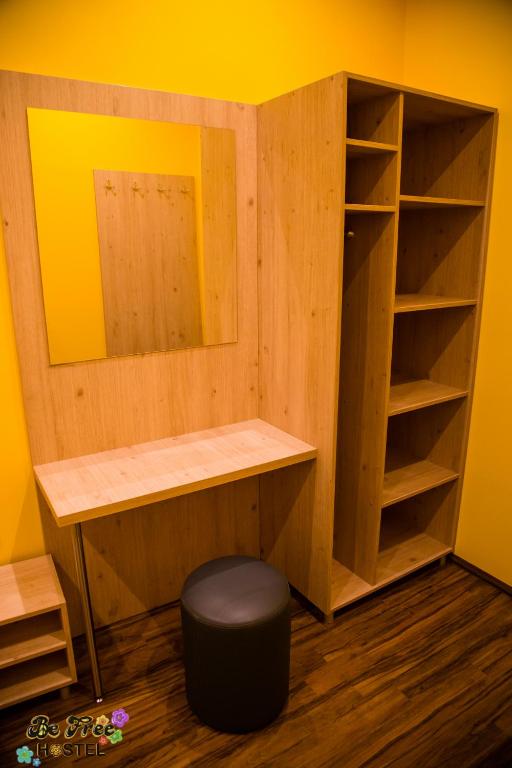 a room with a desk and a shelf and a stool at BeFree Hostel - Self-Service in Vienna