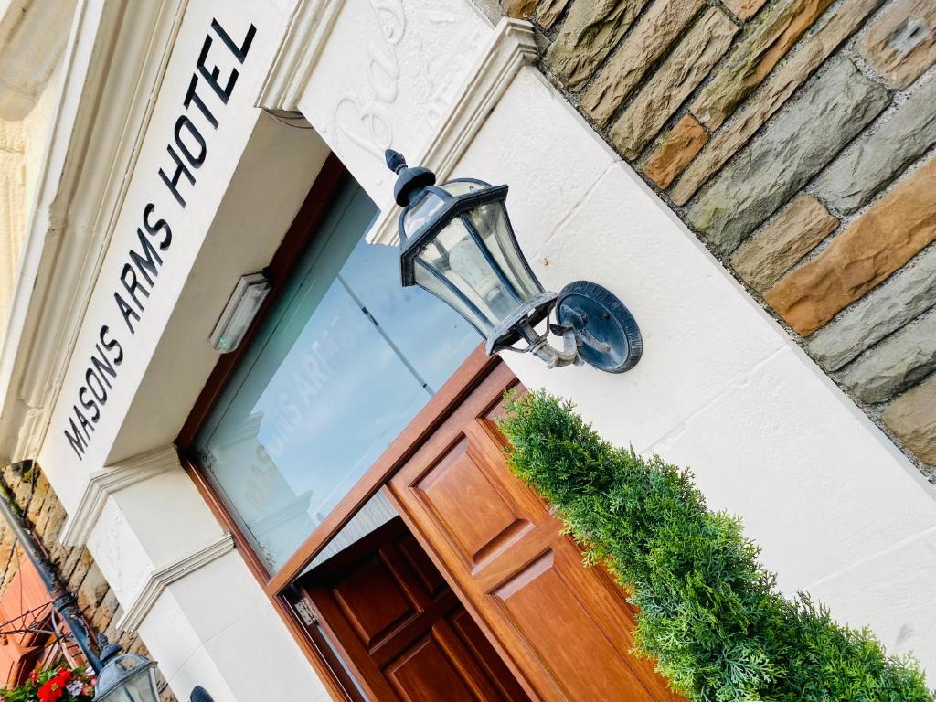 a door to a hotel with a light above it at The Masons Arms Hotel in Bridgend