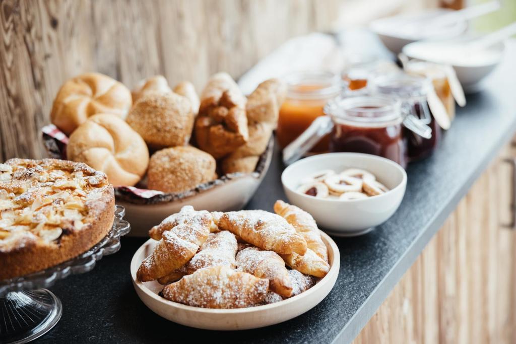 a table with pies and other pastries on it at Garni Ciasa Urban in Badia