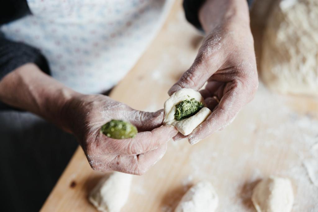 a person holding a piece of food in their hands at Garni Ciasa Urban in Badia