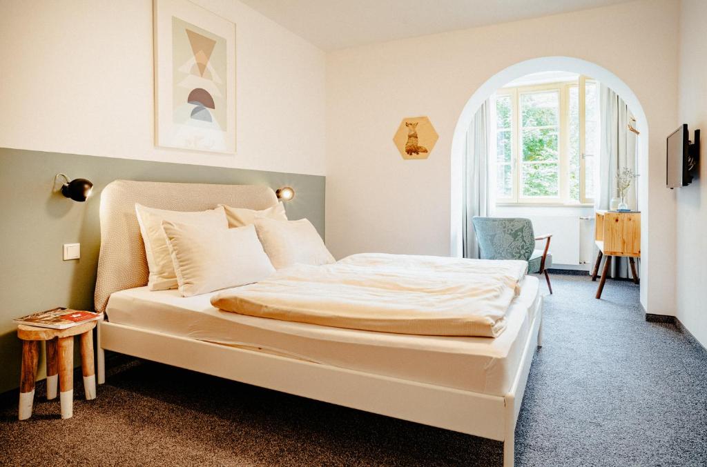 Postel nebo postele na pokoji v ubytování Alpenrose Bayrischzell Hotel