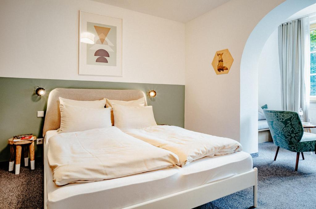 Postel nebo postele na pokoji v ubytování Alpenrose Bayrischzell Hotel