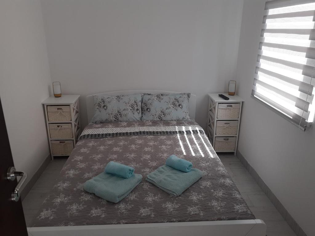 a bedroom with a bed with two pillows on it at Apartman Markovic 2 in Veliko Gradište
