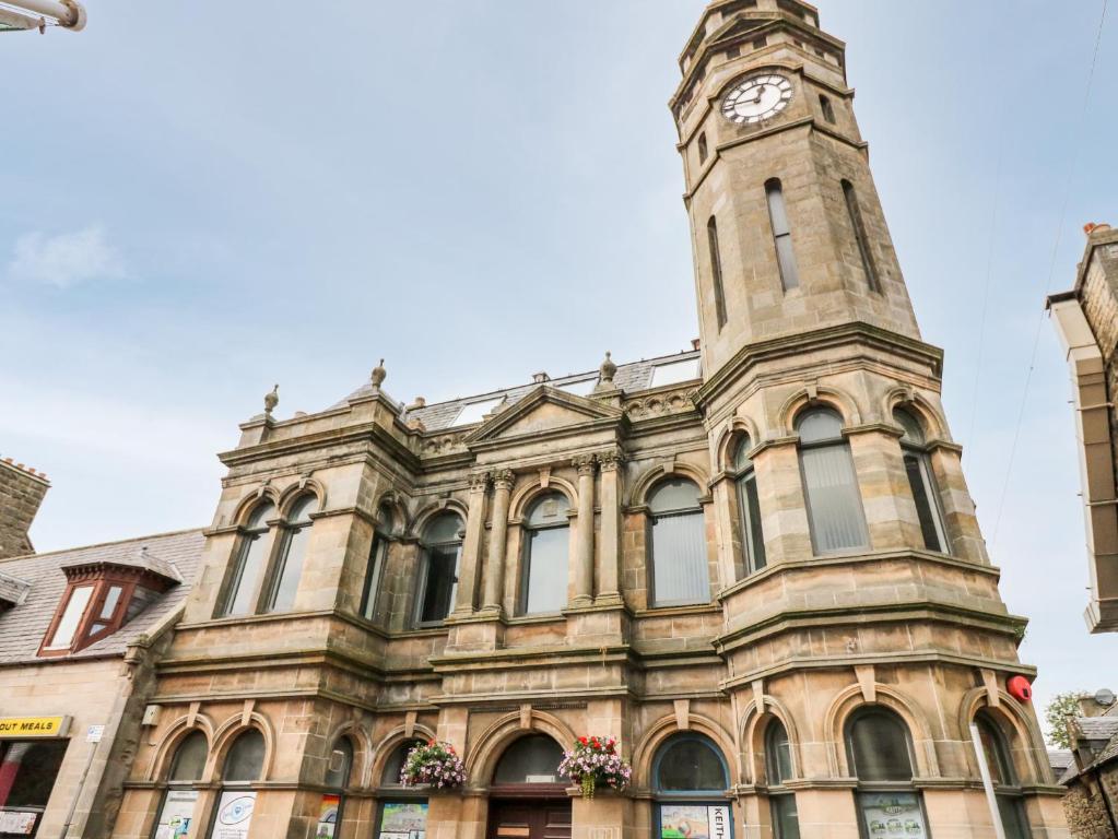 a building with a clock tower on top of it at The Keepers Cottage at The Institute Executive Apartments in Keith