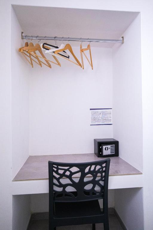 a room with a desk with a chair and shoes on a wall at Donnosanto Residence Pantanagianni in Torre Santa Sabina