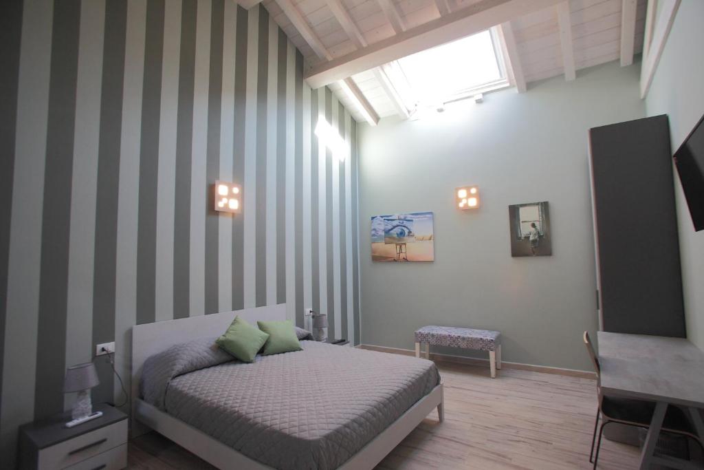 a bedroom with a bed and a desk in it at La CASA DEGLI ARTISTI in Tuscania
