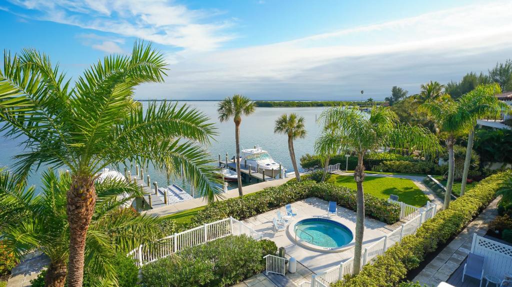 an aerial view of a resort with a swimming pool and palm trees at Harbor Villa Club 309 in Longboat Key