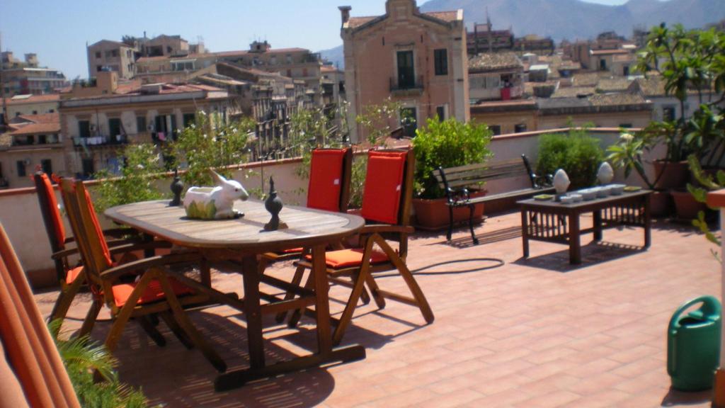 a patio with a table and chairs on a balcony at Alle Terrazze del Borgo Vecchio in Palermo