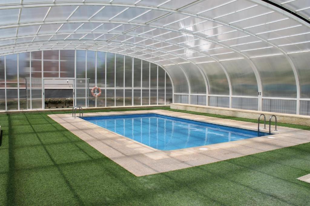 a greenhouse with a swimming pool inside of it at Gemelos 26-Fincas Benidorm in Benidorm