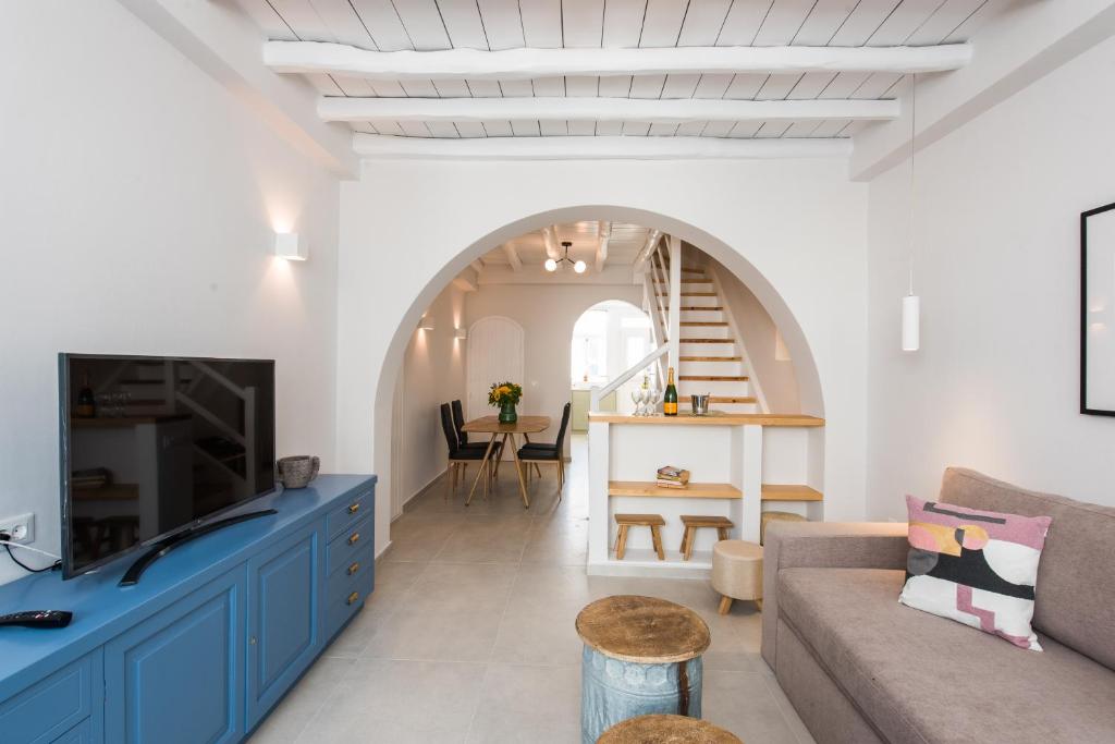 a living room with a couch and a table at The Mykonos Bougainvillea Townhouse in Mýkonos City
