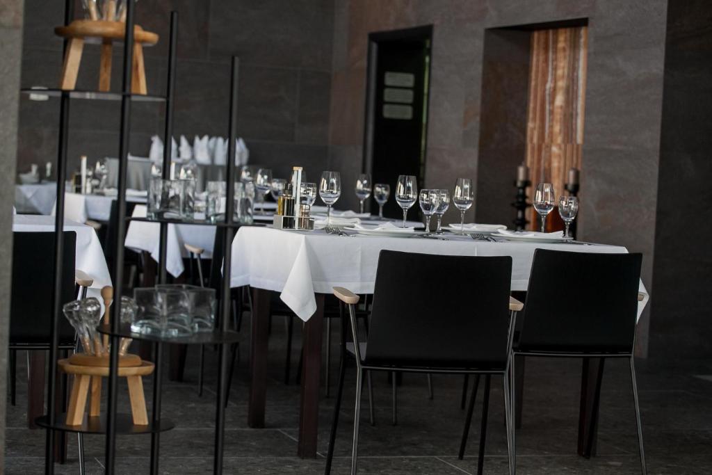 a dining room with a table with wine glasses at Boutique Hotel Bura 45N in Senj
