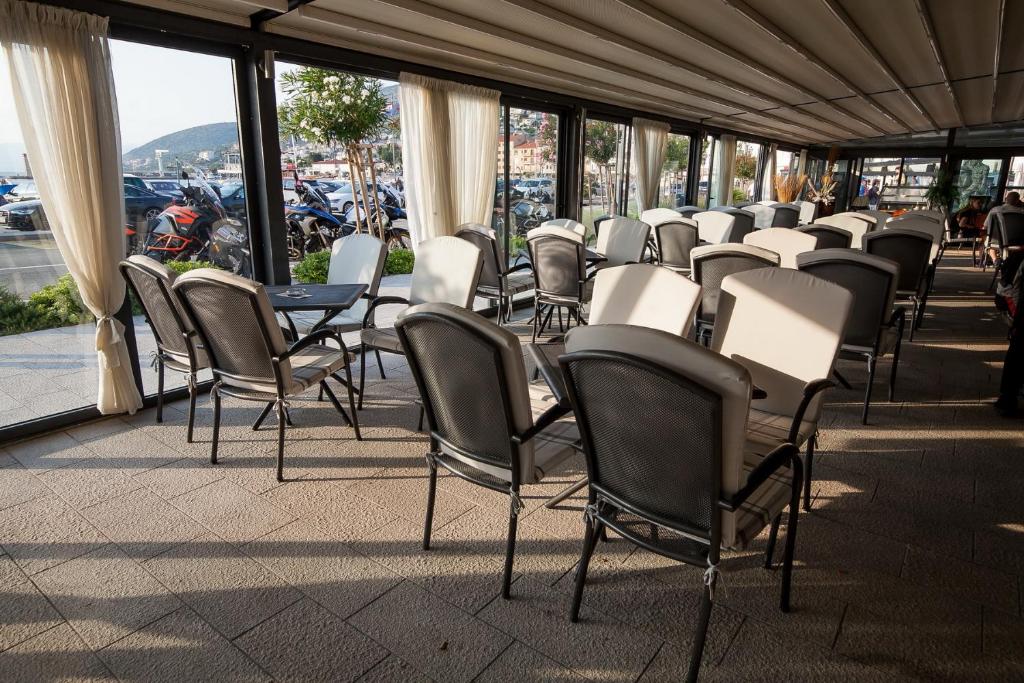 a row of chairs and tables in a building at Boutique Hotel Bura 45N in Senj