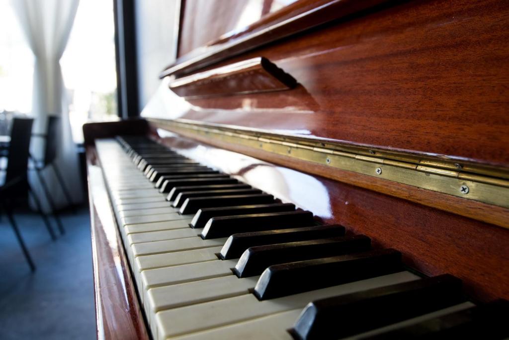 a wooden piano sitting in a room at Boutique Hotel Bura 45N in Senj