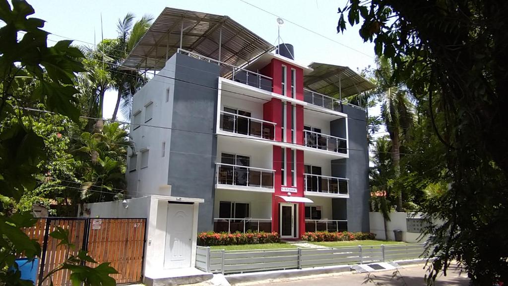 a building with red shutters on it at SolyViento 67 in Cabarete