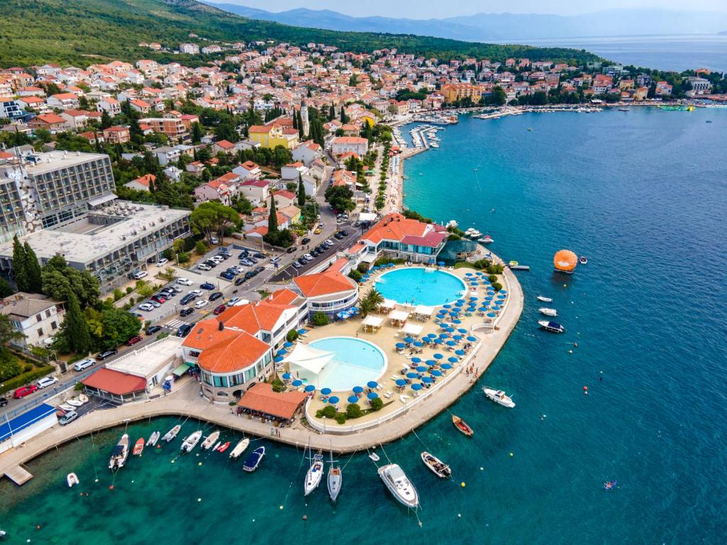 an aerial view of a resort with boats in the water at Hotel Millenium deluxe in Selce