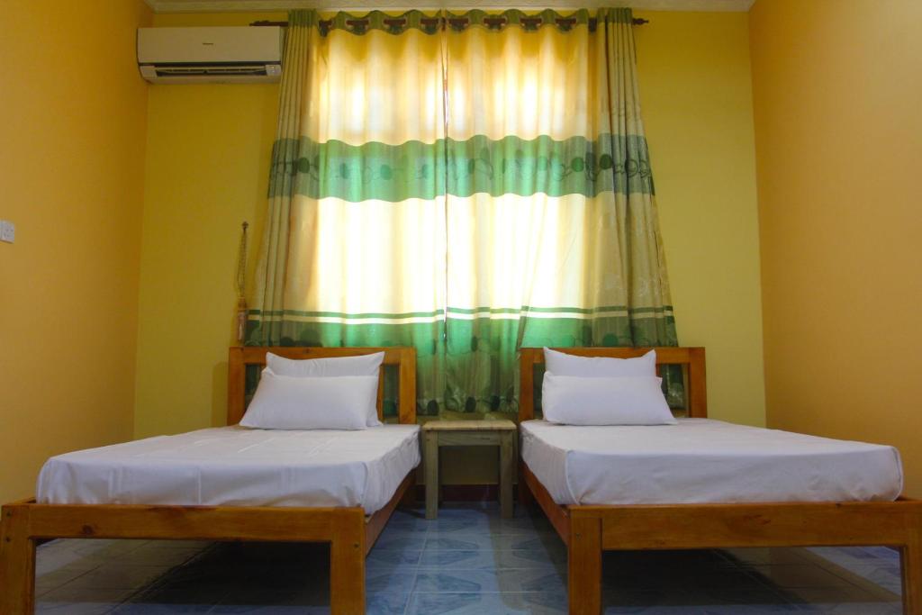 Postel nebo postele na pokoji v ubytování Jail Break Surf Inn