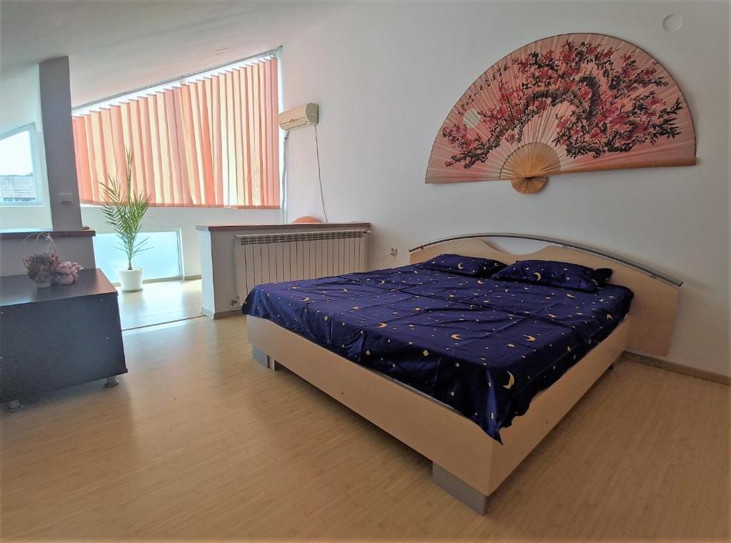 シビウにあるTimes Square Sibiuのベッドルーム1室(青い掛け布団付きのベッド1台付)