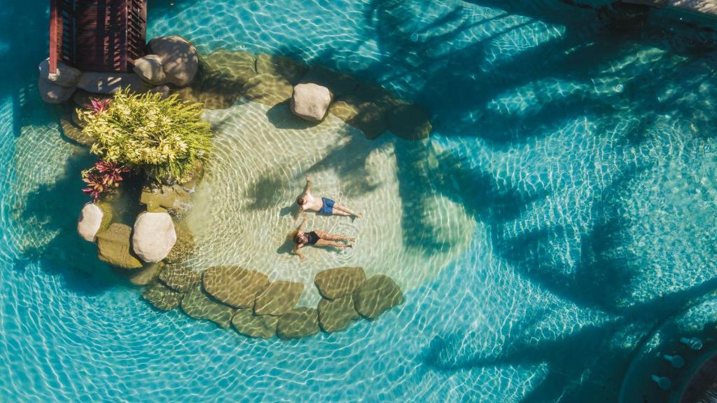 an overhead view of two people on an island in the water at Borinquen Thermal Resort in Liberia