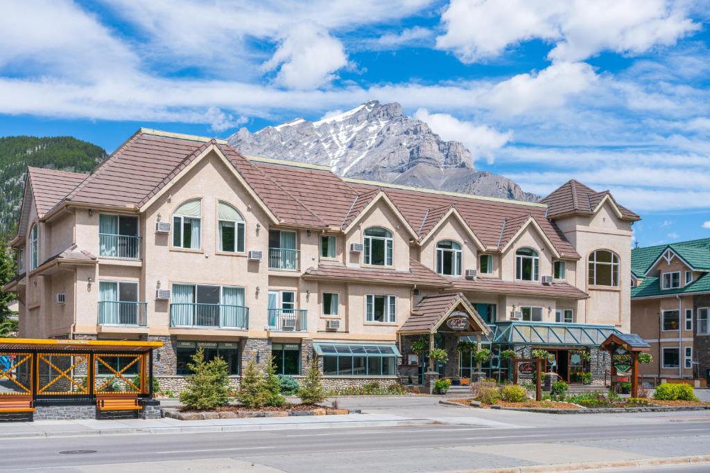 a large building with a mountain in the background at Irwin&#39;s Mountain Inn in Banff