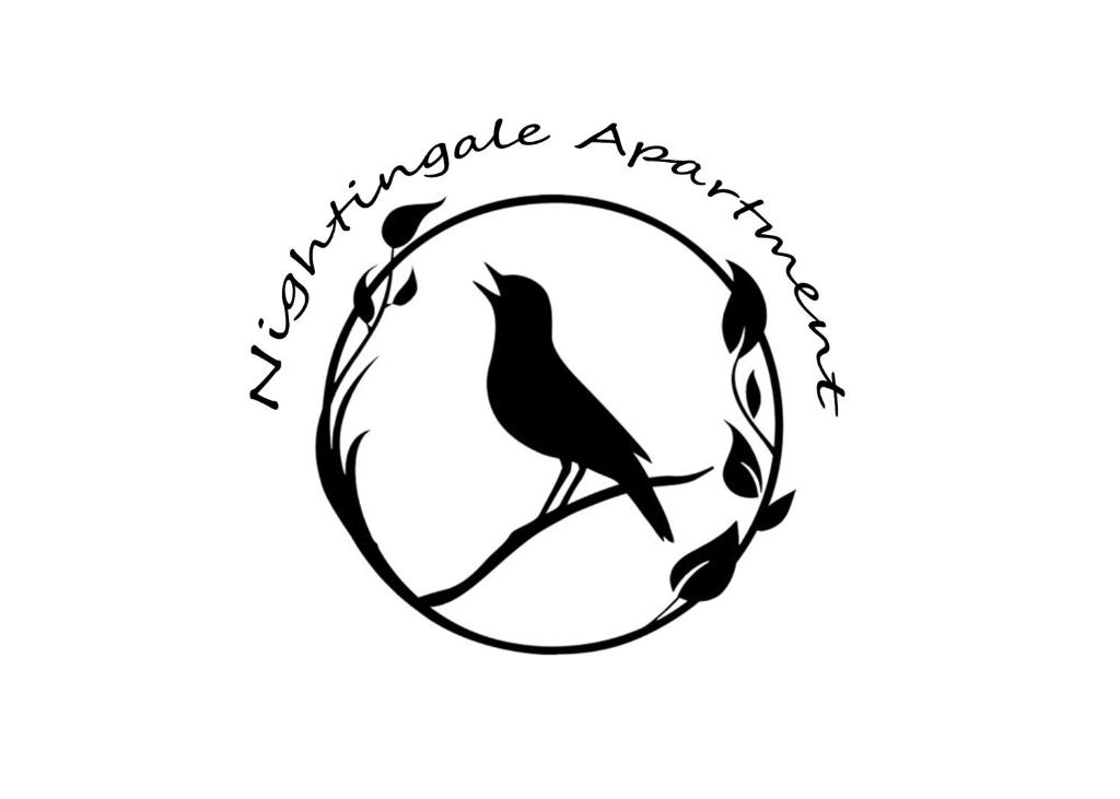 a bird sitting on a branch in a circle logo at Nightingale Luxury Apartment in Budapest