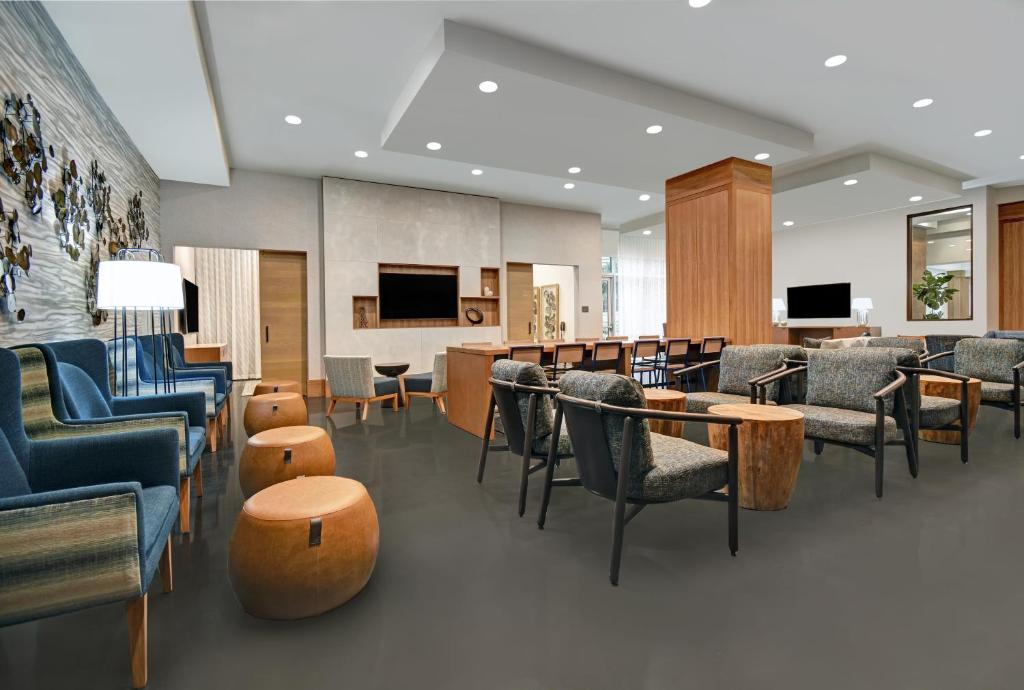 a lobby with chairs and tables and a waiting room at Holiday Inn Express - Houston - Galleria Area by IHG in Houston