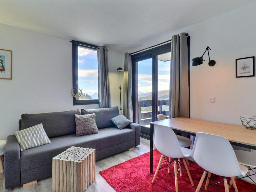 a living room with a couch and a table at Appartement Méribel, 2 pièces, 4 personnes - FR-1-182-240 in Les Allues