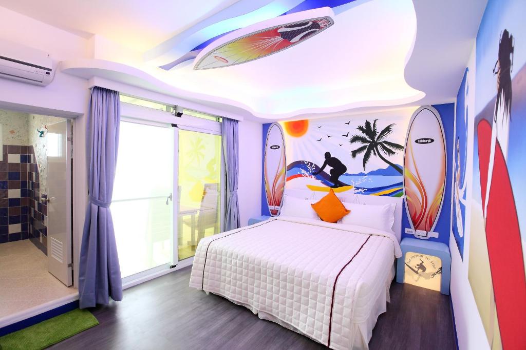 a bedroom with a bed with surfboards on the wall at Edinburgh 16 Inn in Hengchun