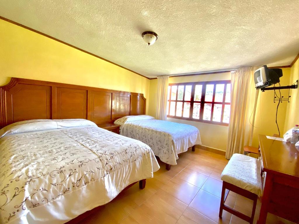 Postel nebo postele na pokoji v ubytování Posada Castillo