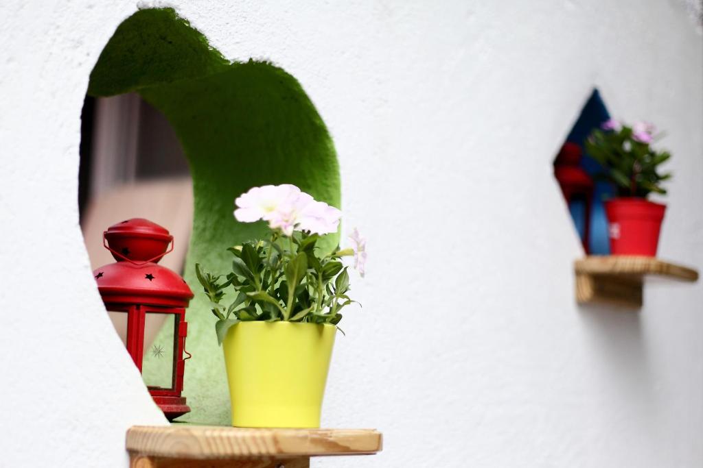 a yellow vase with flowers in it next to a lamp at Edinburgh 16 Inn in Hengchun