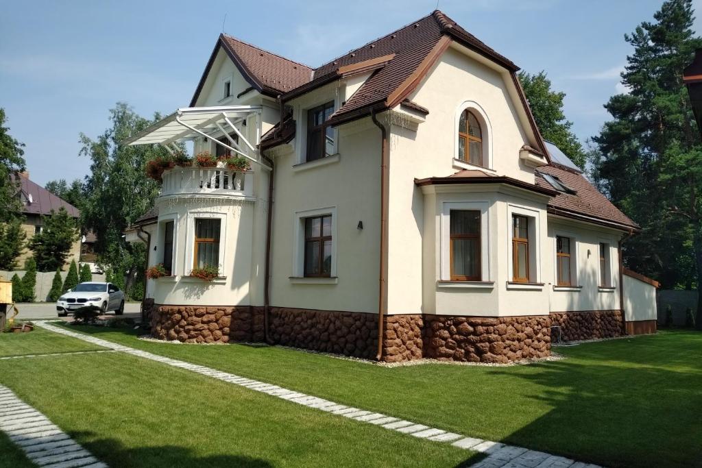 a house with a lawn in front of it at Villa Garden Apartments in Poprad