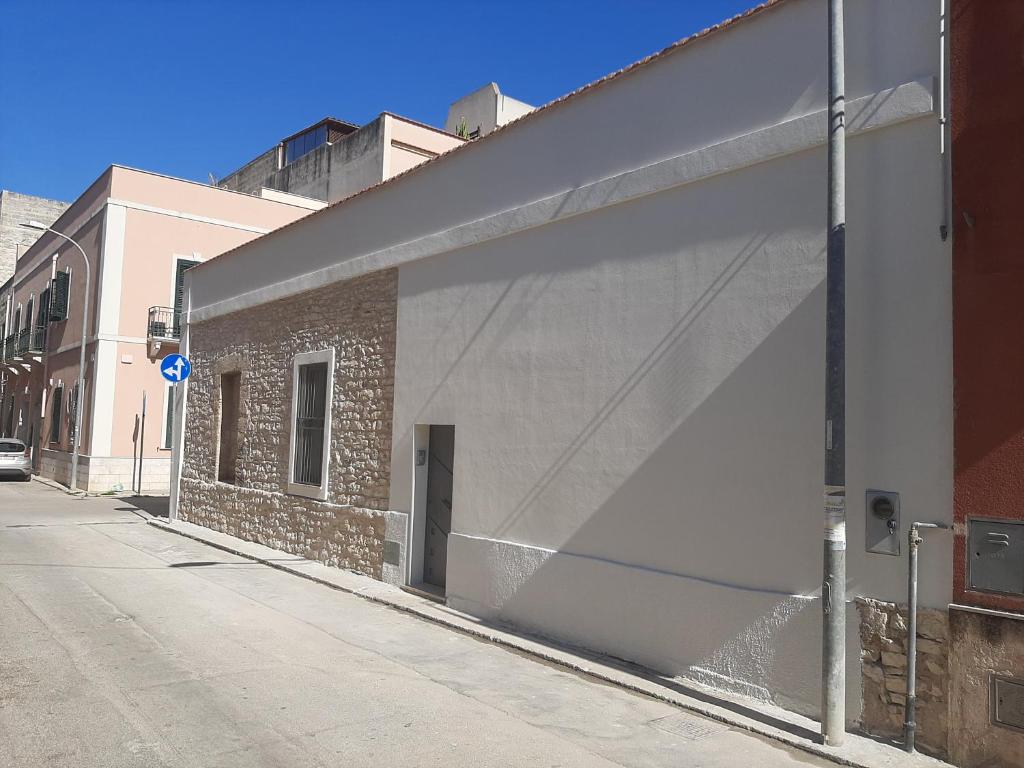 a large white garage door on the side of a building at La casetta di pietra in Trapani