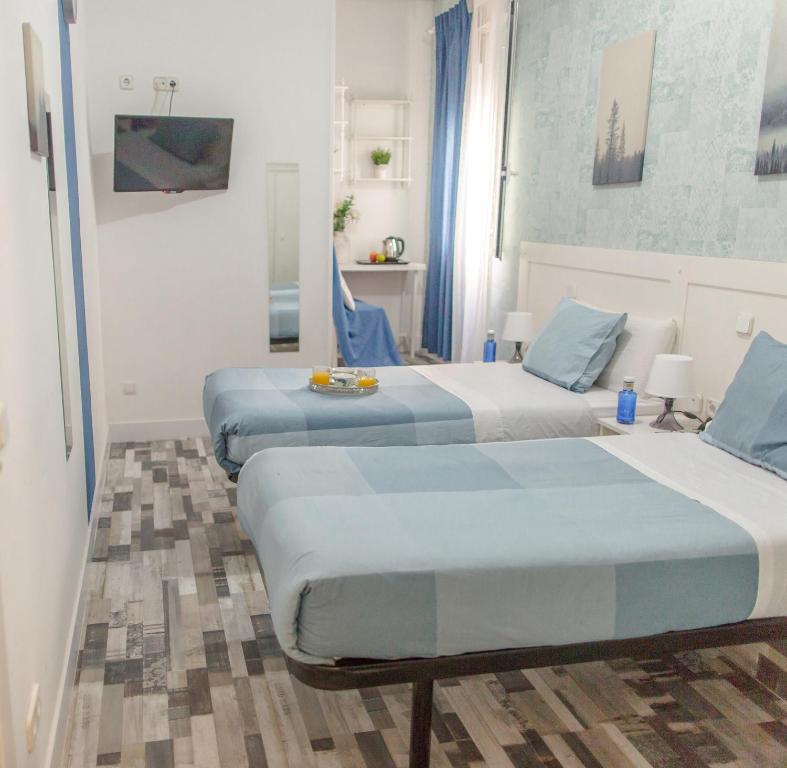 Cama o camas de una habitación en Fuencarral Adeco