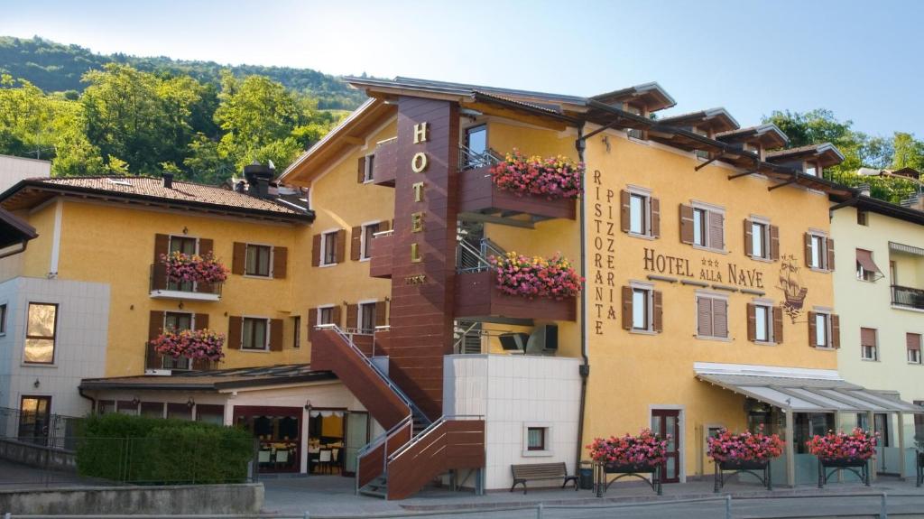 a hotel with a staircase in front of a building at Hotel Ristorante Alla Nave in Lavis