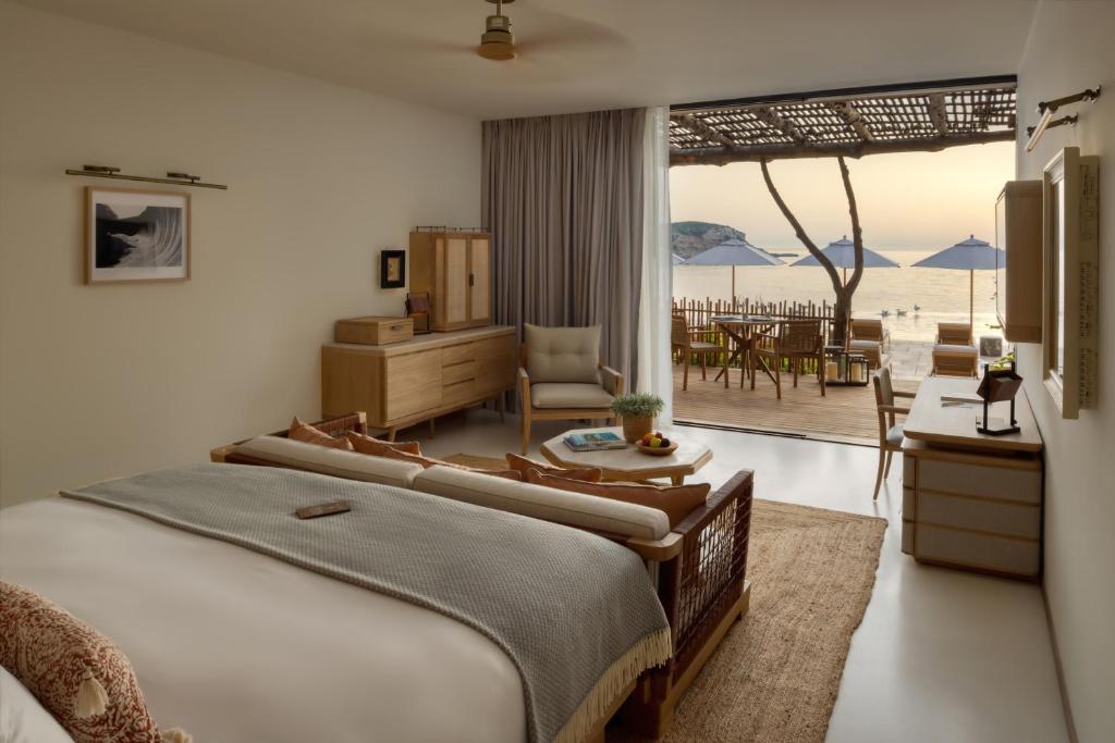 a bedroom with a bed and a view of the ocean at Six Senses Ibiza in Portinatx