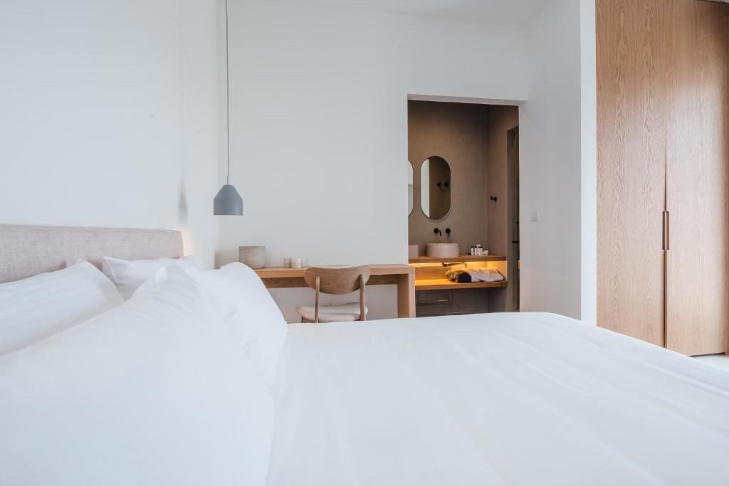 Łóżko lub łóżka w pokoju w obiekcie Amarelo Suites