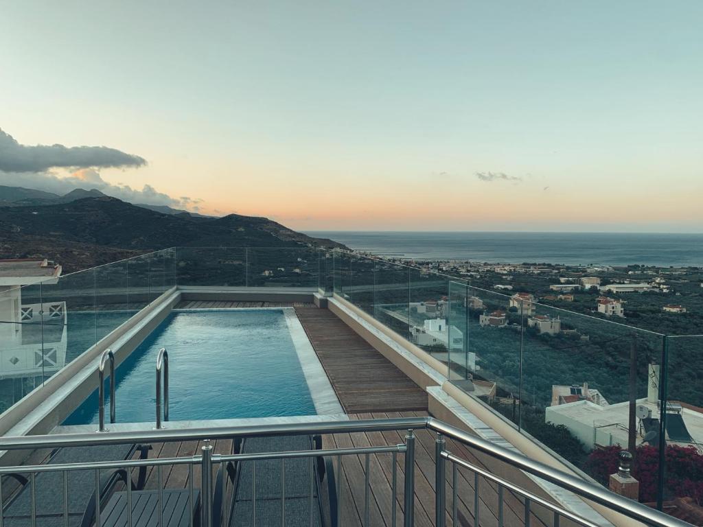 a swimming pool on the top of a building at King Crimson Luxury Apartments in Marathokefála