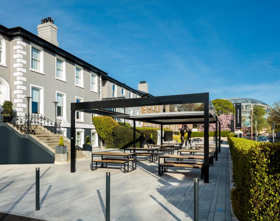 a row of benches in front of a building at Sandymount Hotel in Dublin