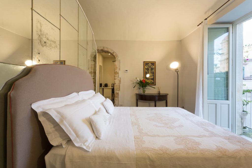 Postel nebo postele na pokoji v ubytování San Carlo Suites