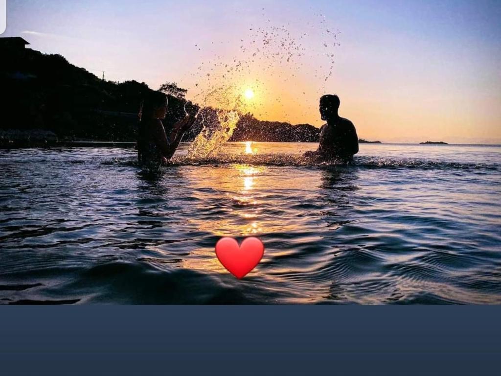 two people in the water with a heart in the water at B&B BALANI Rooms in Shkodër
