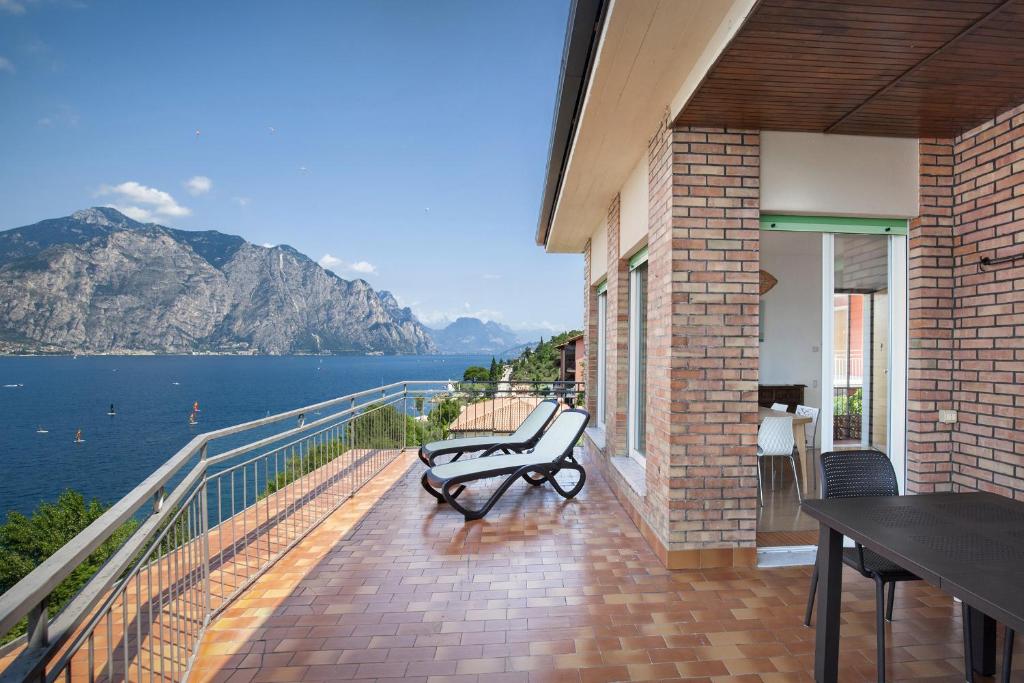 a bench on a balcony with a view of the water at Apartment Windows On The Lake in Malcesine