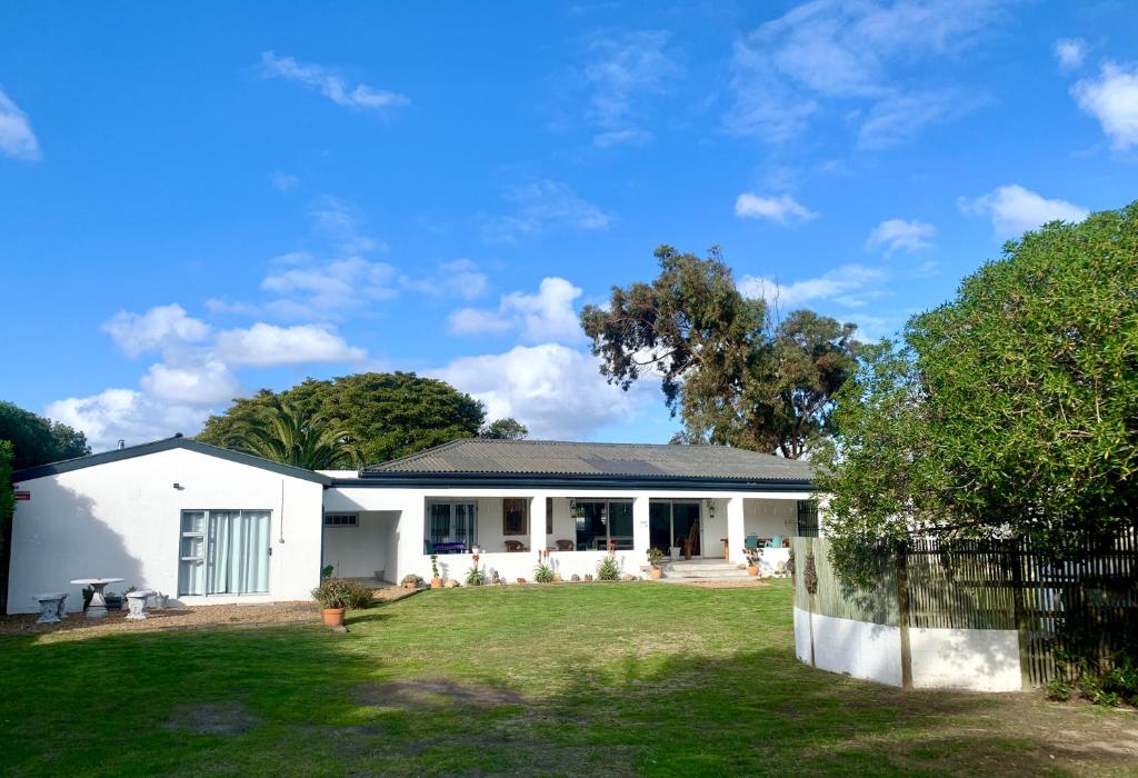 a white house with a yard at Always Summer Guesthouse in Langebaan