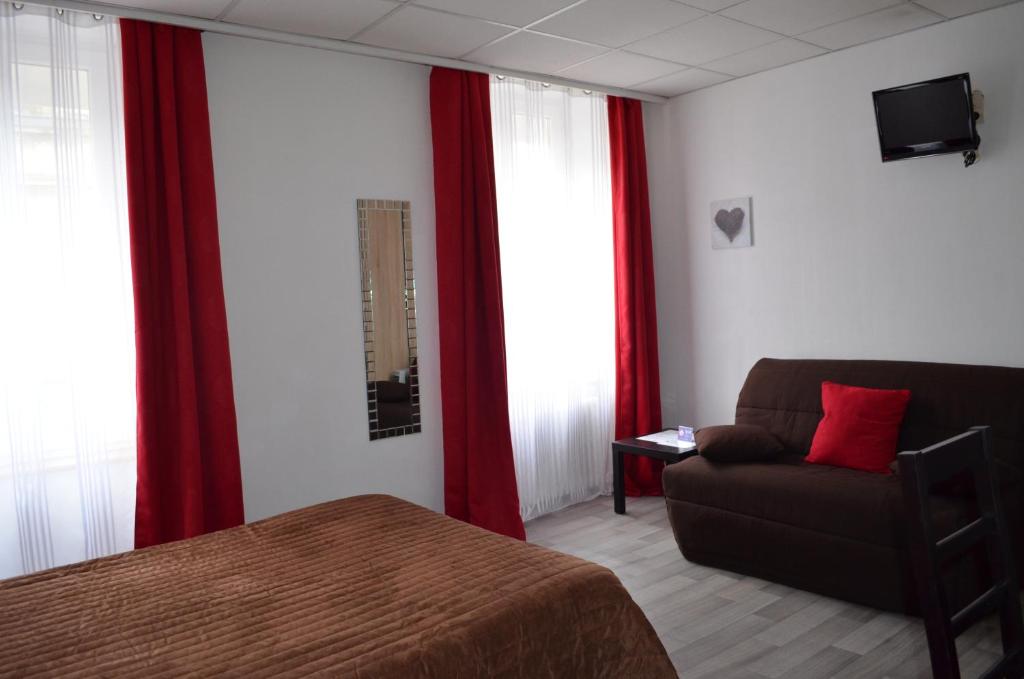 a bedroom with a bed and a couch and red curtains at Hôtel de La Croix de Malte in Cherbourg en Cotentin