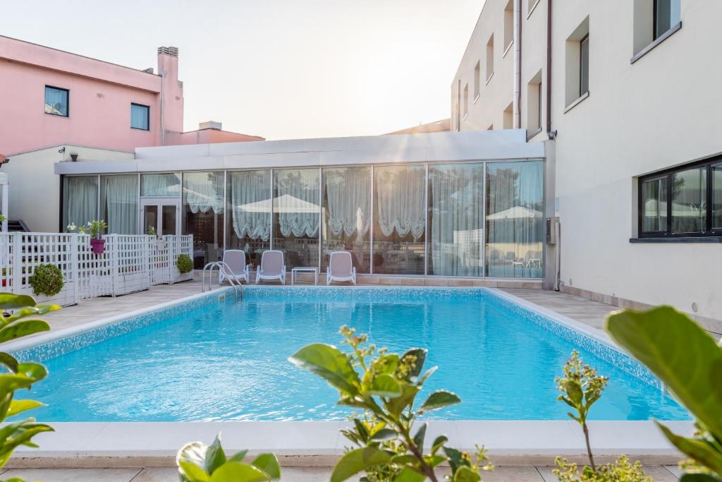 a swimming pool in the middle of a building at Hotel Concorde in Camerano