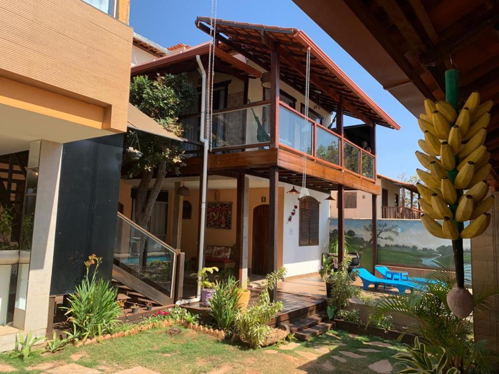 una casa con balcón y un montón de plátanos en Pousada Hibisco, en Serra do Cipo